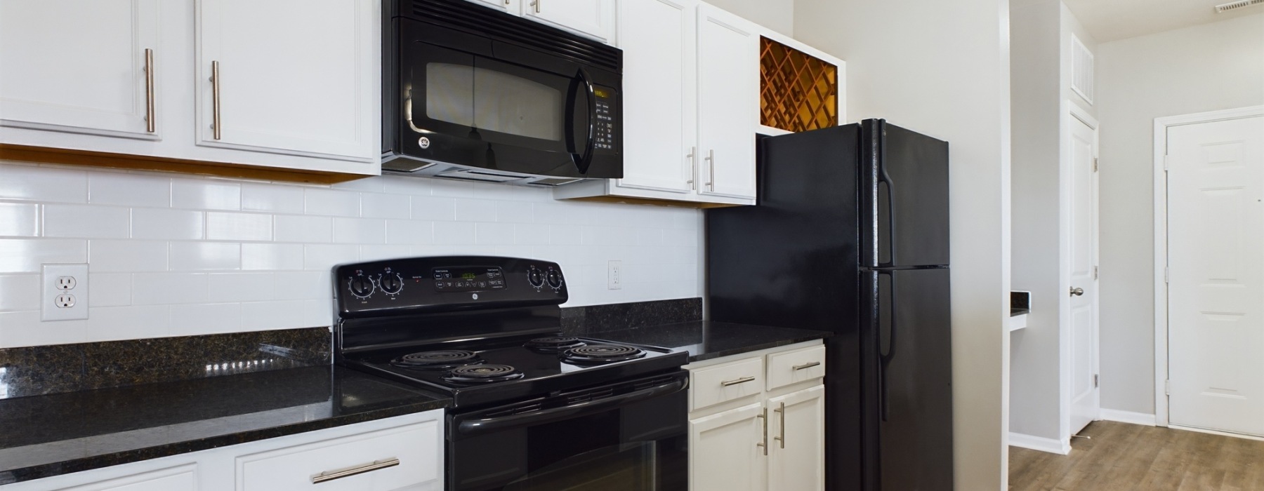 kitchen with white cabinets and black appliances