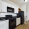 kitchen with white cabinets and black appliances