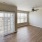Living room with large windows and a ceiling fan