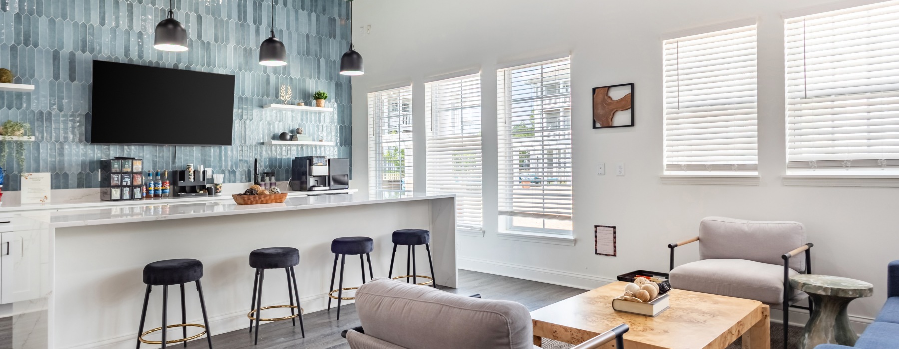 Clubhouse lounge with large tv and kitchen