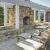 outdoor chairs and tables in front of pergola covered fireplace