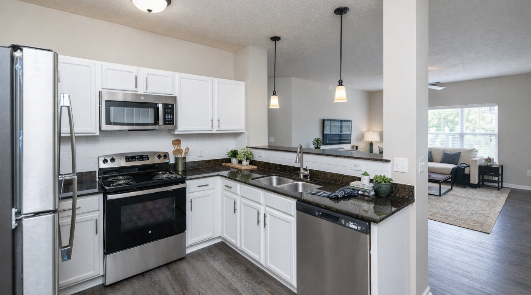 Staged kitchen with view of living room